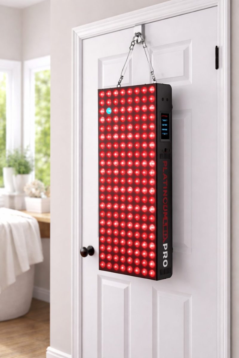 PlatinumLED BIOMAX Pro Ultra red light therapy panel mounted on a door using hanging hardware, designed for at-home skin rejuvenation and recovery for women over 40.
