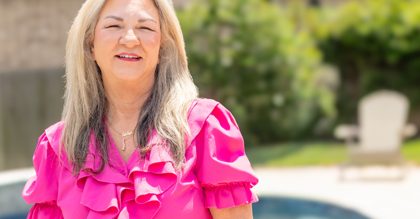 Smiling woman over 50 with radiant Satin Skin makeup by Beauty with AS pro-aging artistry.